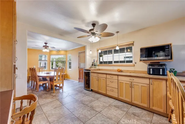 a room with stainless steel appliances kitchen island granite countertop furniture and a kitchen view