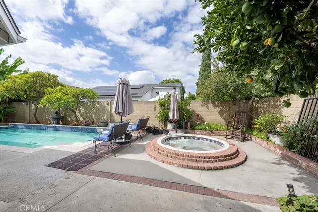 a view of a house with backyard sitting area and garage