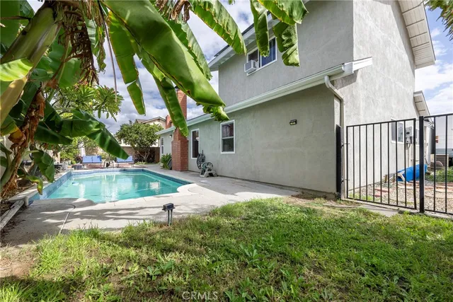 a room with furniture a flat screen tv and kitchen view