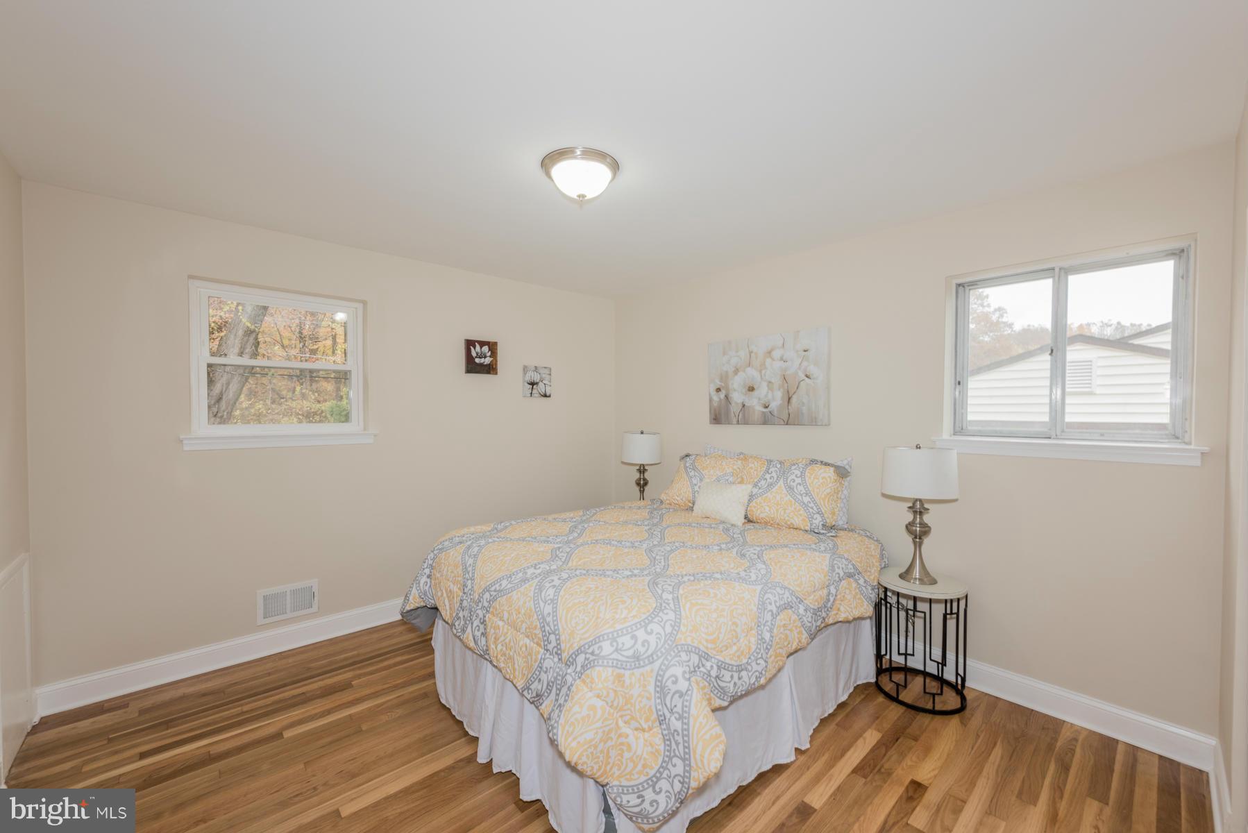 3812 Collier Road Randallstown, MD 21133 - Photo 12 of 27 a bedroom with a bed and a table