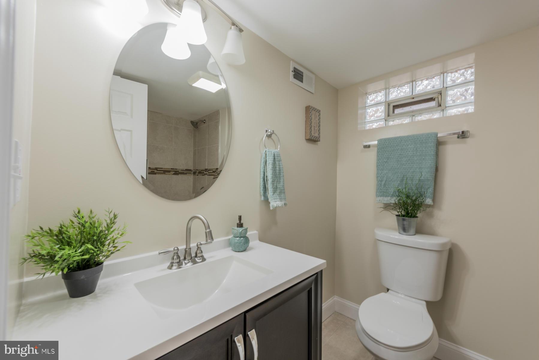 3812 Collier Road Randallstown, MD 21133 - Photo 25 of 27 a bathroom with a toilet sink and mirror