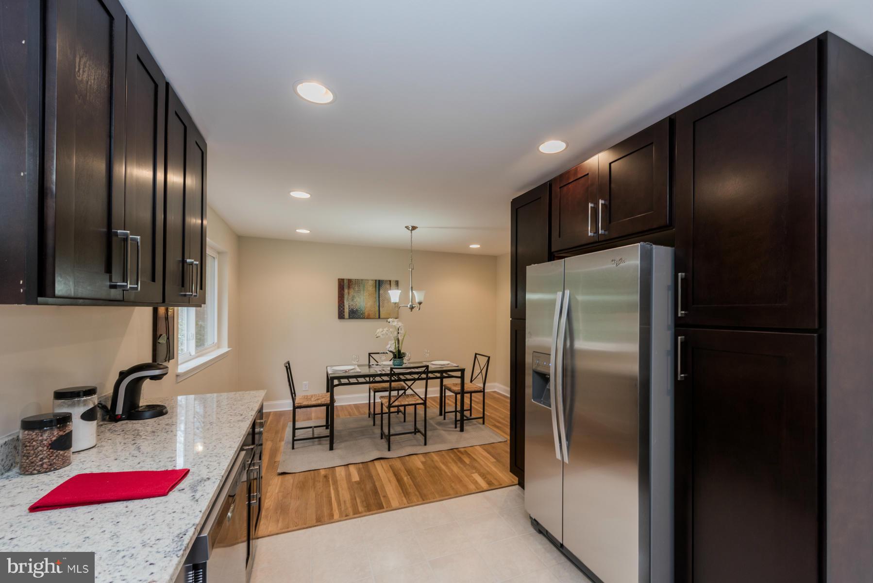 3812 Collier Road Randallstown, MD 21133 - Photo 10 of 27 a kitchen with stainless steel appliances granite countertop a refrigerator and a more cabinets