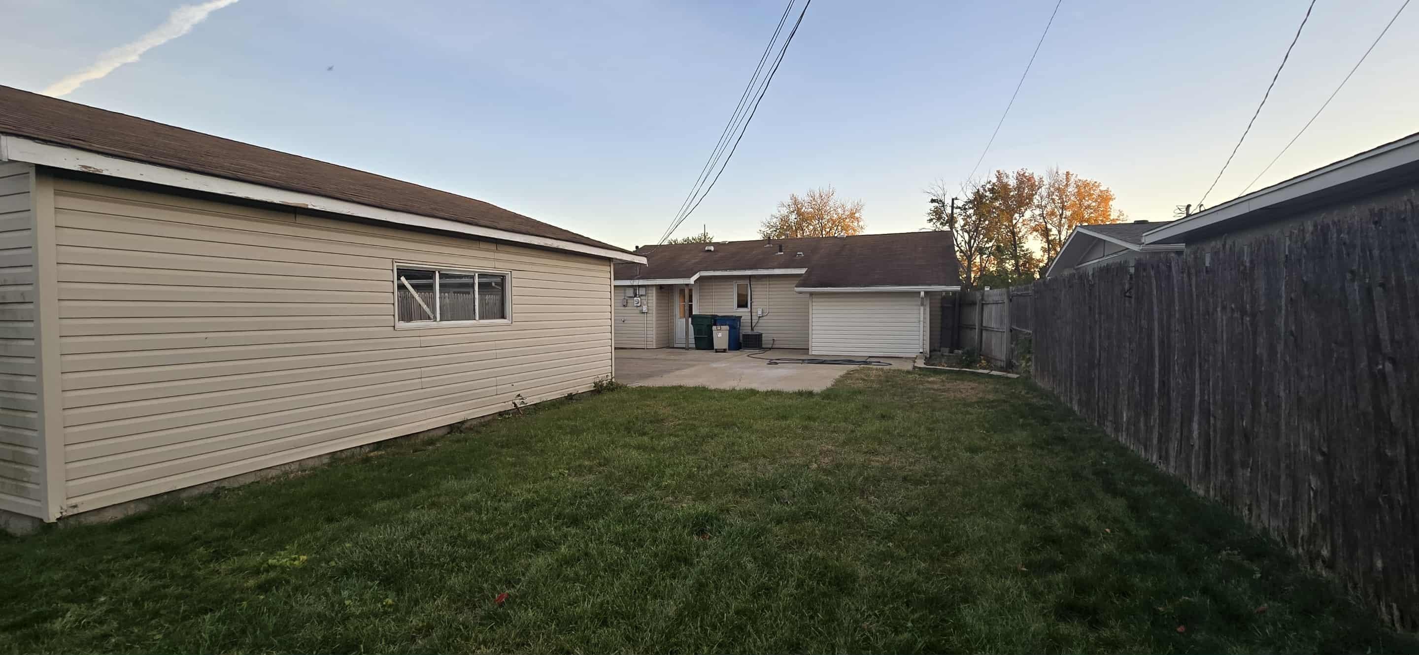 3339 176th Place Hammond, IN 46323 - Photo 16 of 16 a view of a backyard with plants and wooden fence