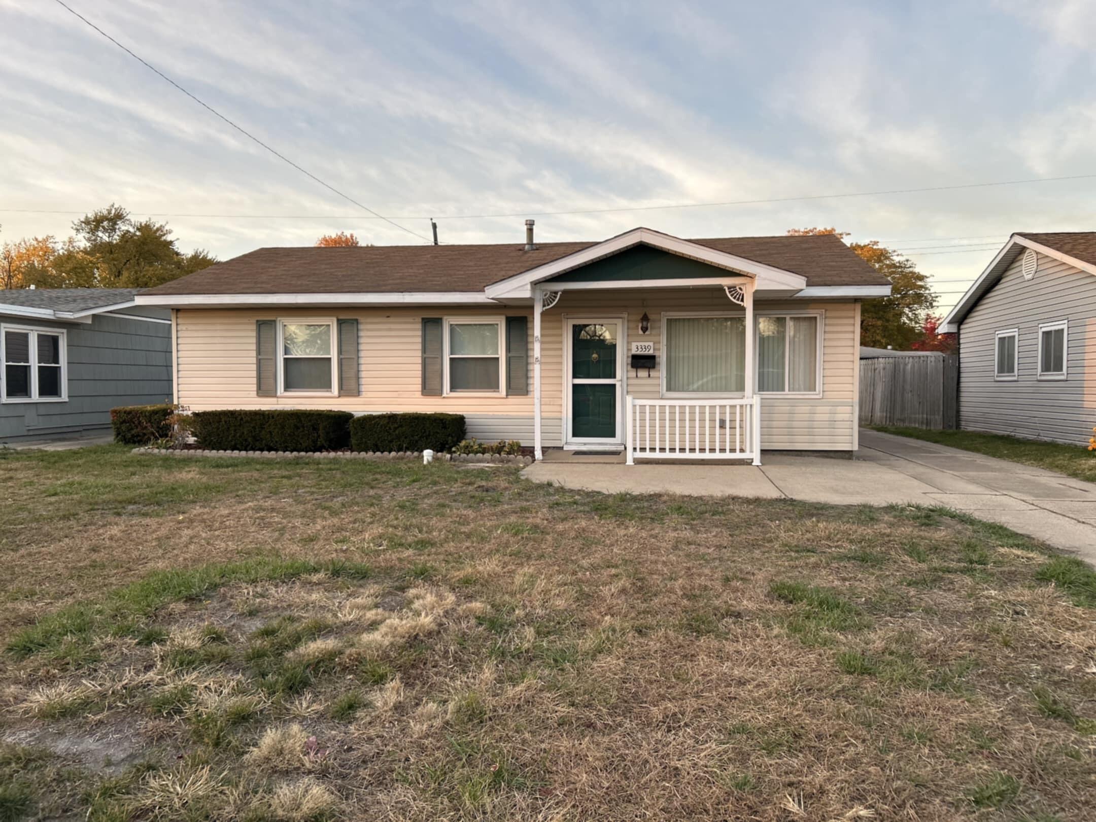 3339 176th Place Hammond, IN 46323 - Photo 2 of 16 a front view of a house with a garden
