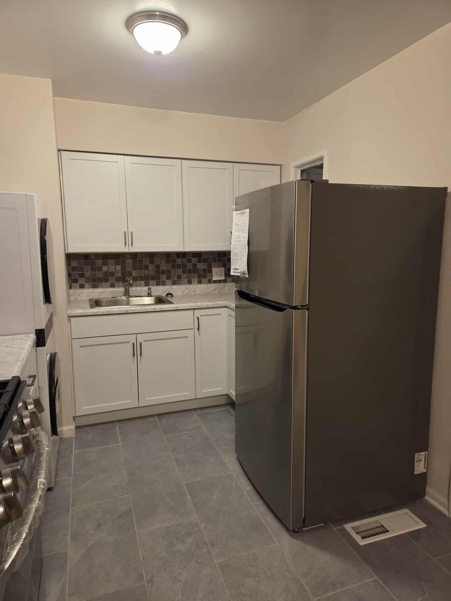 3339 176th Place Hammond, IN 46323 - Photo 6 of 16 a kitchen with a refrigerator and a sink