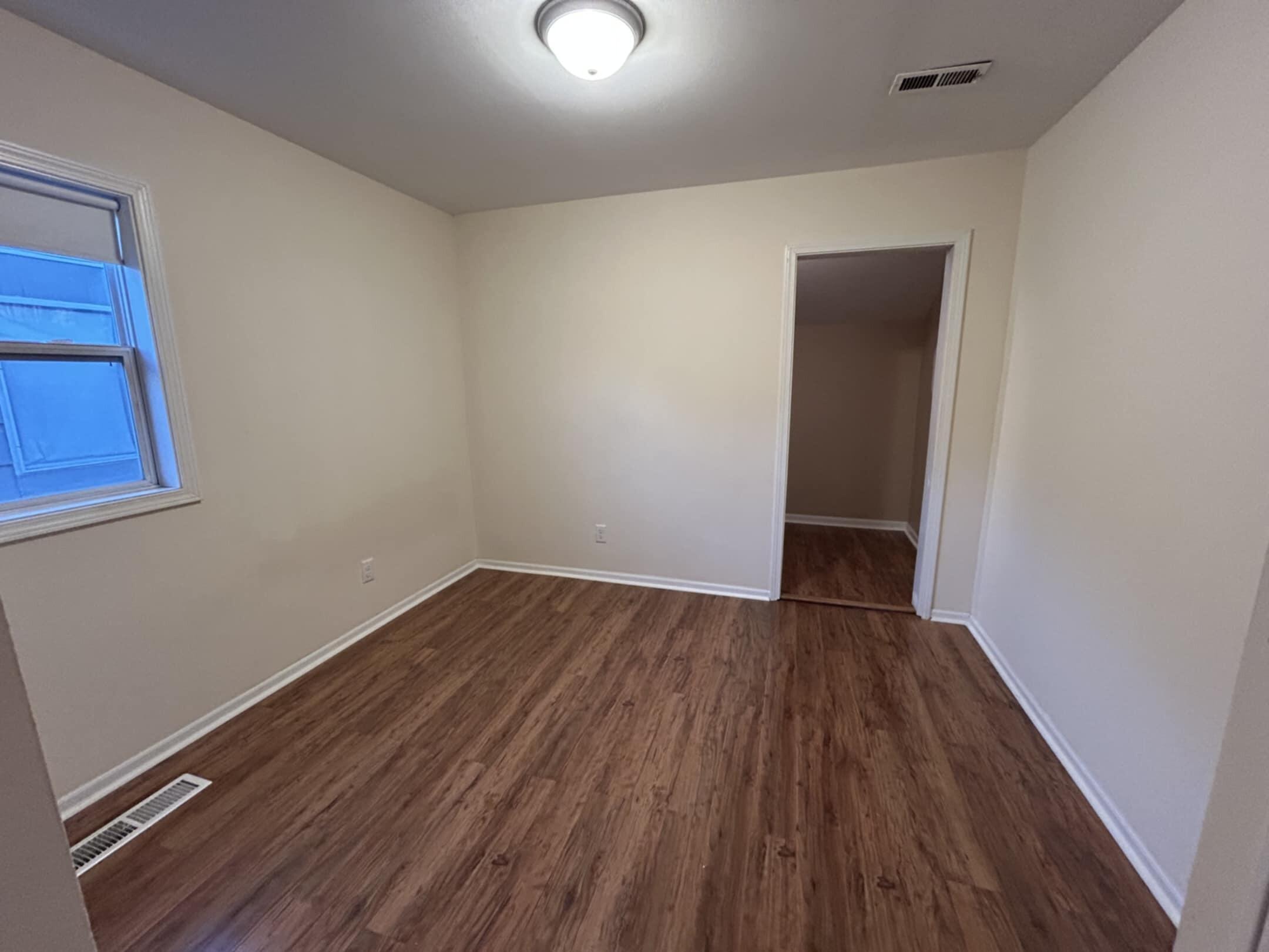 3339 176th Place Hammond, IN 46323 - Photo 7 of 16 a view of an empty room with wooden floor