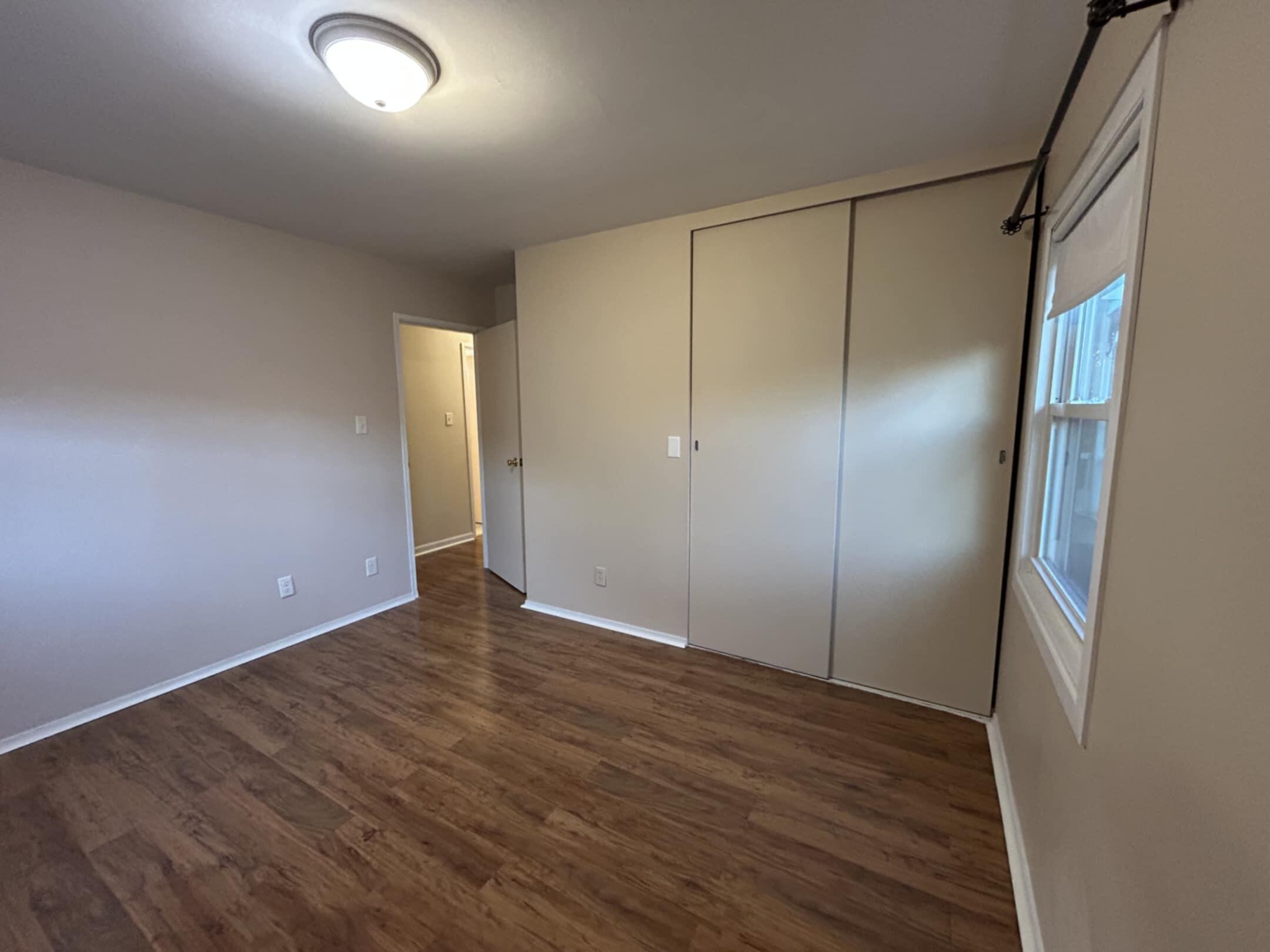 3339 176th Place Hammond, IN 46323 - Photo 8 of 16 an empty room with wooden floor and sliding door