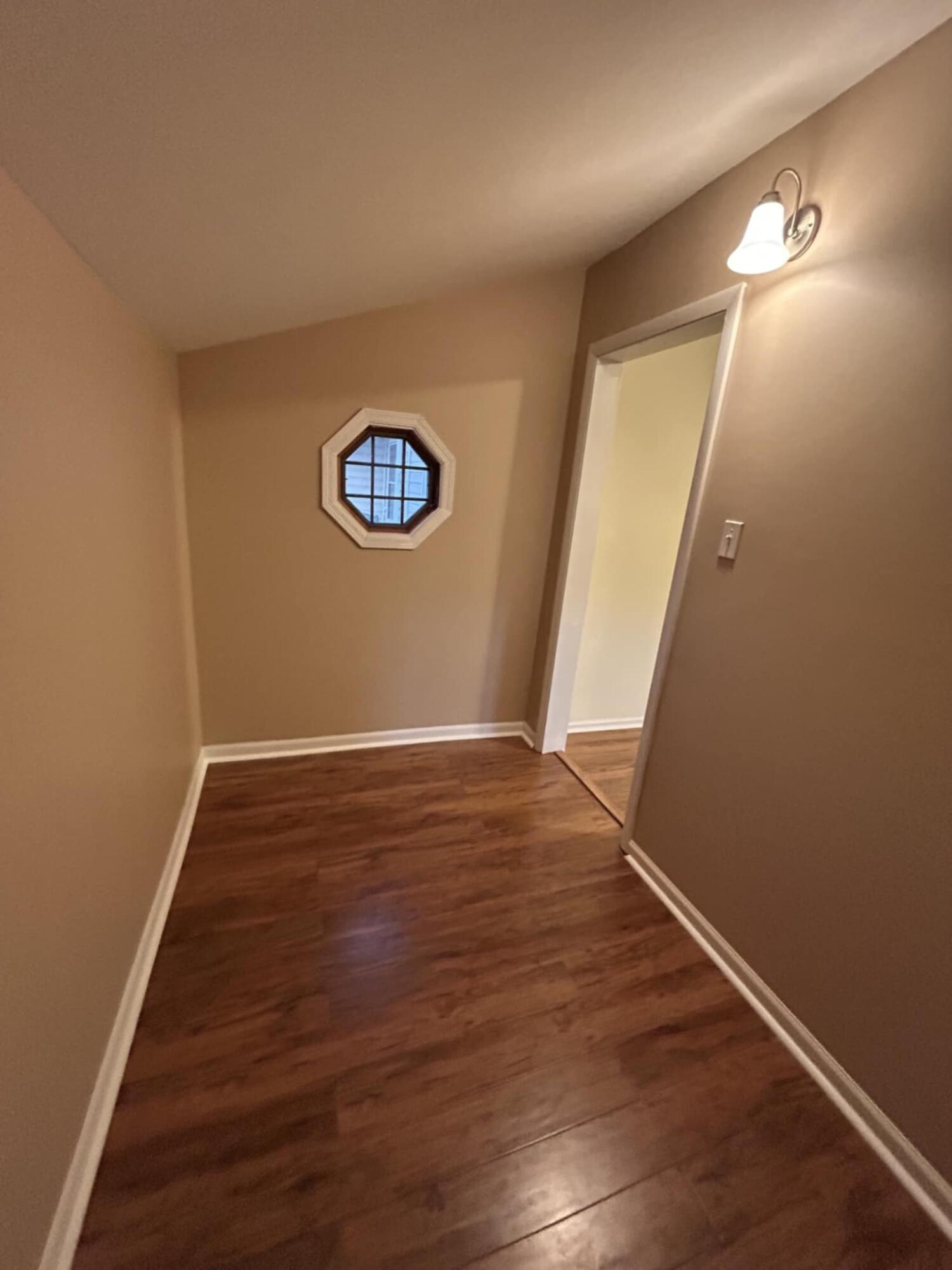 3339 176th Place Hammond, IN 46323 - Photo 9 of 16 an empty room with wooden floor and white wall