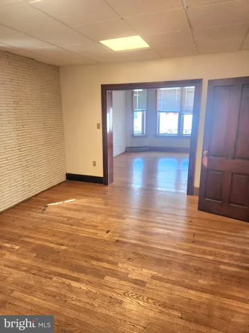 a kitchen with stainless steel appliances granite countertop a sink a stove a refrigerator a dining table and chairs