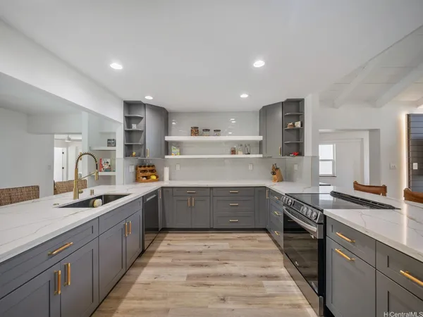 a kitchen with kitchen island granite countertop a sink and cabinets