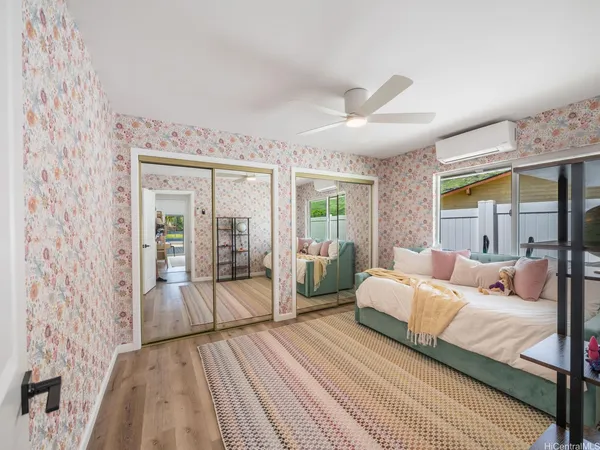 a bedroom with a large bed and a chandelier