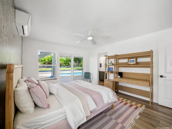 a bedroom with a bed and a large window