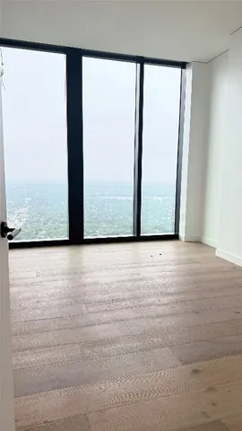 a view of an empty room and wooden floor