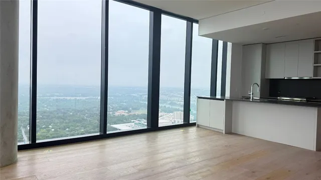 a view of a room with wooden floor and a window