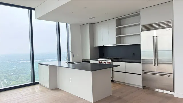 a kitchen with stainless steel appliances a refrigerator and cabinets