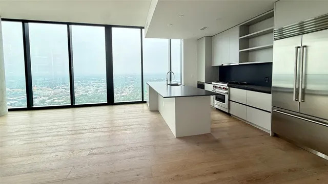 a view of a refrigerator in kitchen and wooden floor