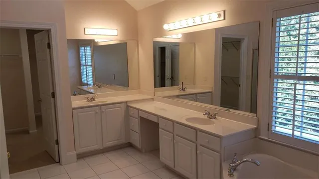 a bathroom with a sink vanity and mirror