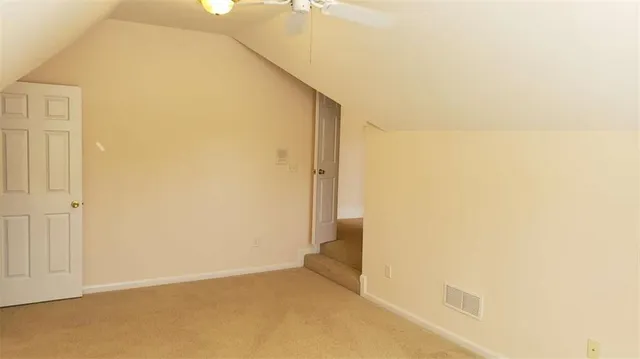 a view of an empty room and a window