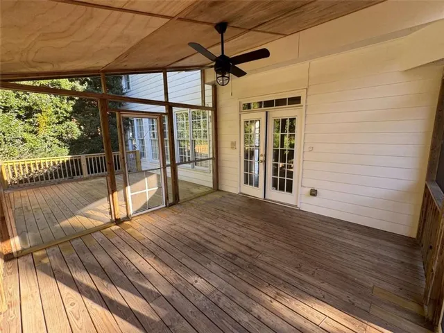 a view of backyard with deck and wooden floor