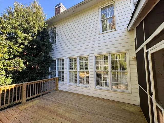 a view of a deck with a chair and wooden floor