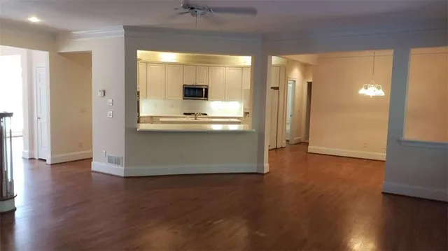 a view of kitchen with stainless steel appliances wooden floor