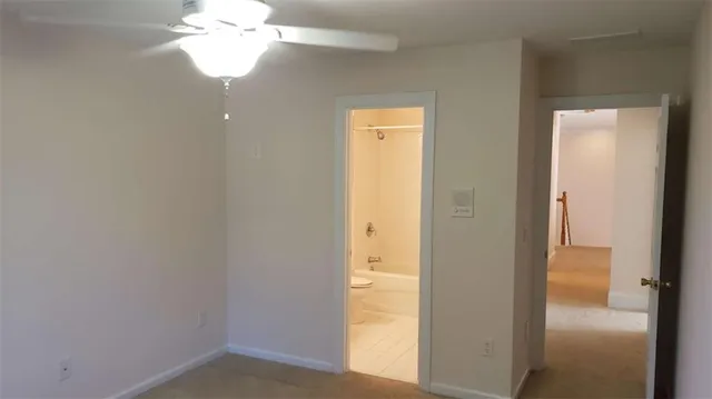 a view of a hallway with a chandelier fan
