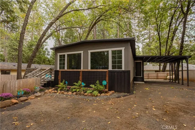 a front view of a house with a garden