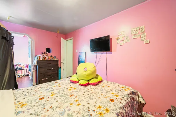 a bedroom with a bed and a flat screen tv