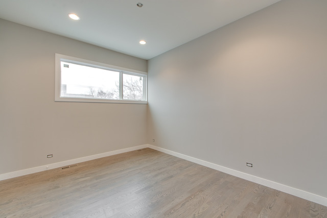 2042 West Rice Street, Unit 3 Chicago, IL 60622 - Photo 12 of 19 an empty room with wooden floor and windows