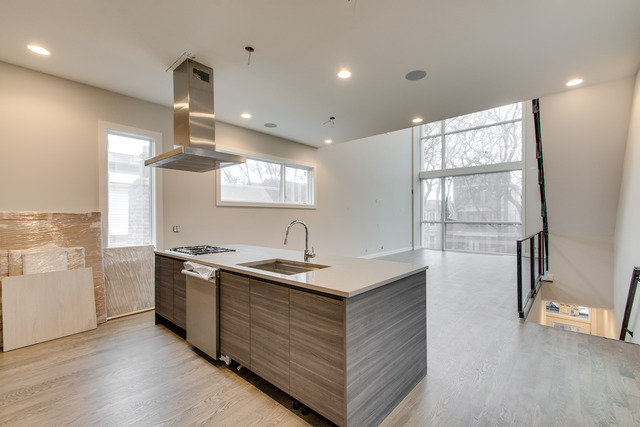 2042 West Rice Street, Unit 3 Chicago, IL 60622 - Photo 4 of 19 a kitchen with stainless steel appliances granite countertop a sink a stove and a refrigerator