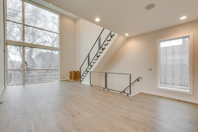 2042 West Rice Street, Unit 3 Chicago, IL 60622 - Photo 6 of 19 an empty room with windows and wooden floor