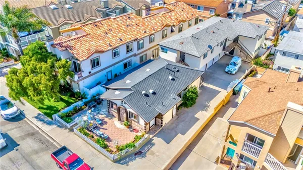 an aerial view of a house with a yard and potted plants