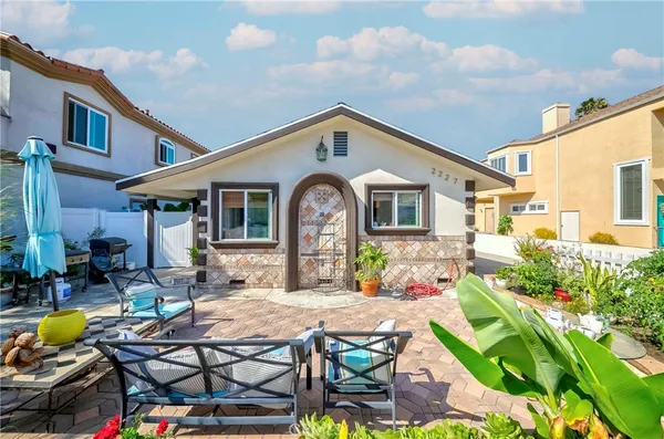 a front view of house with yard outdoor seating and barbeque oven