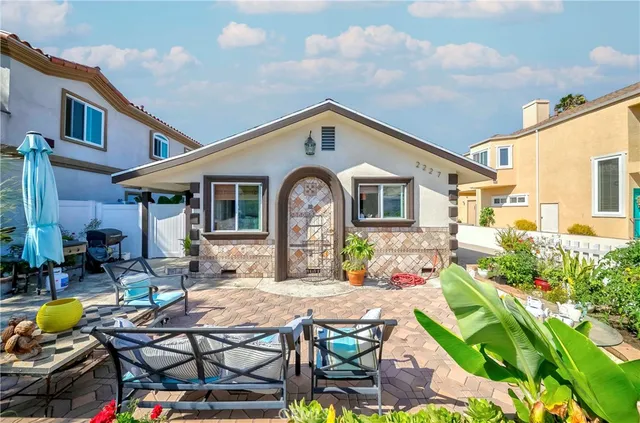 a front view of house with yard outdoor seating and barbeque oven