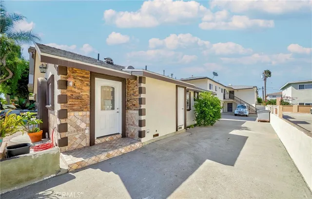 a view of a patio with table and chairs and potted plants