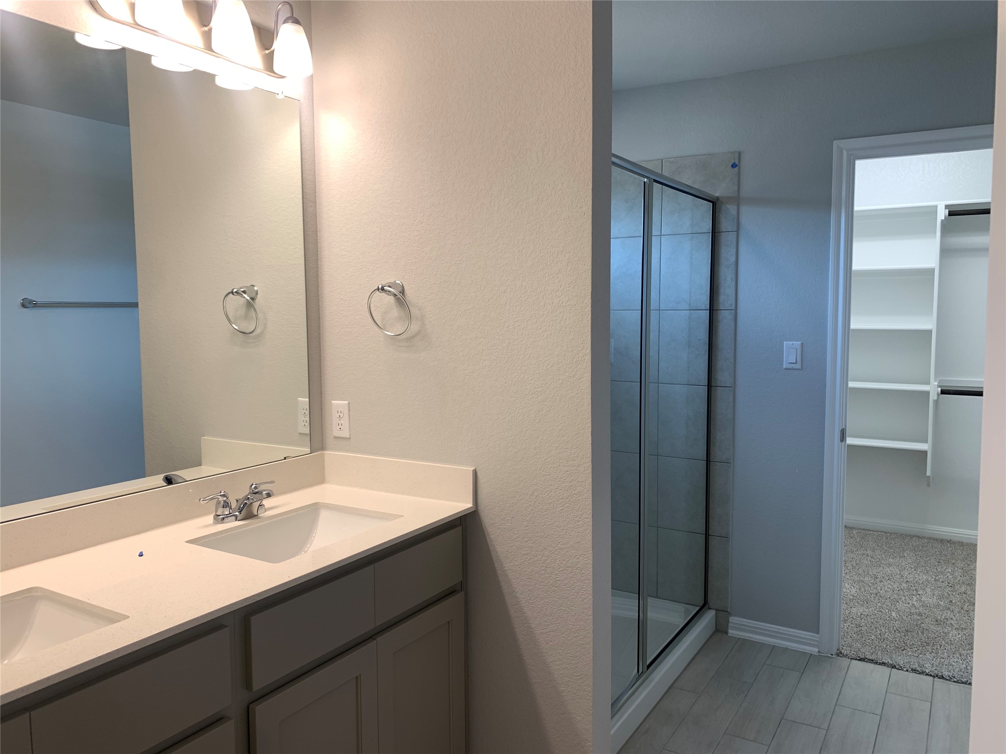 2948 Sage Ranch Drive Leander, TX 78641 - Photo 11 of 28 Double vanity and a spacious walk-in shower elevate this primary bathroom's appeal.