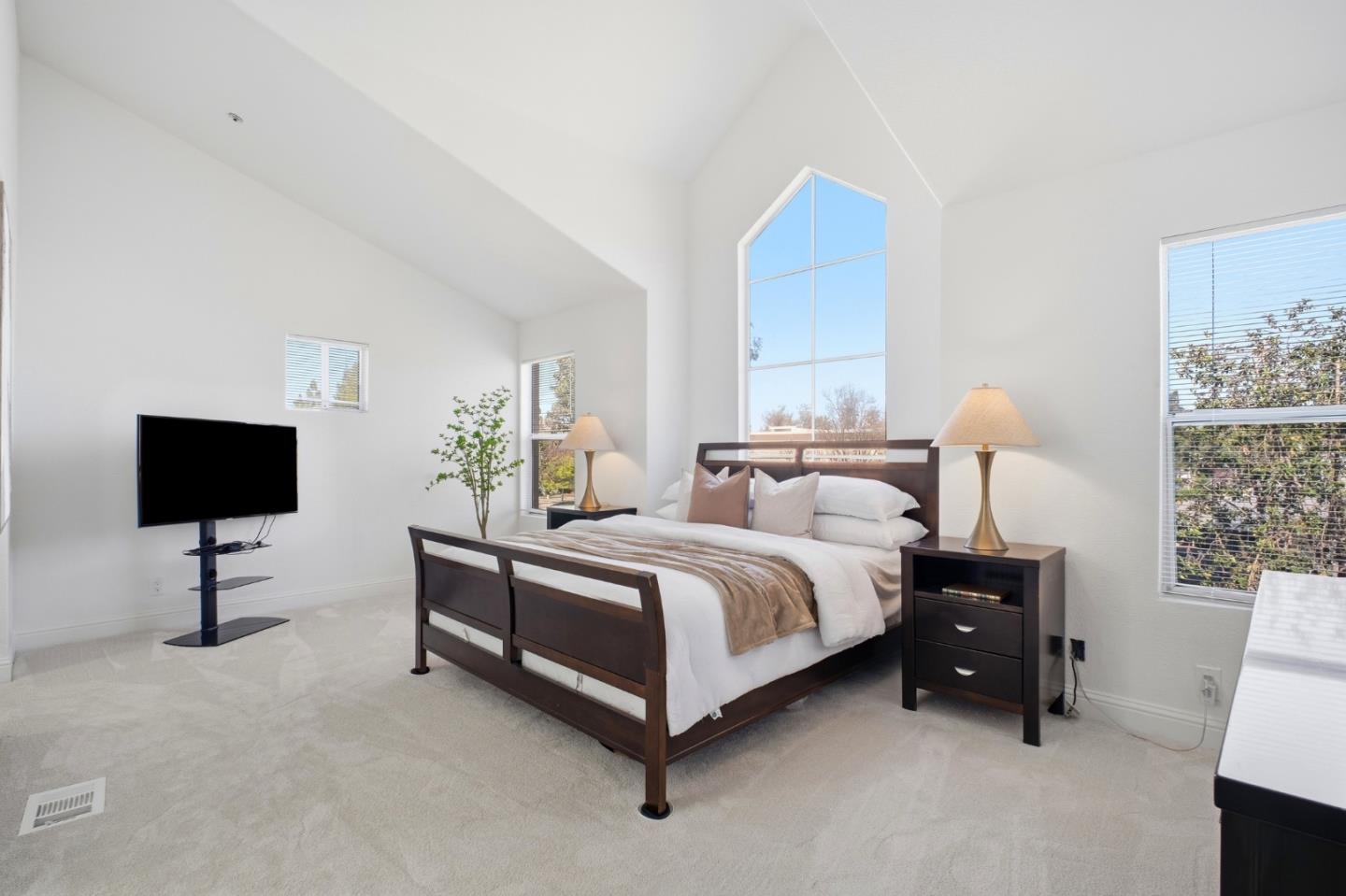 3950 Paul Terrace Fremont, CA 94538 - Photo 15 of 28 a spacious bedroom with a bed and a lamp
