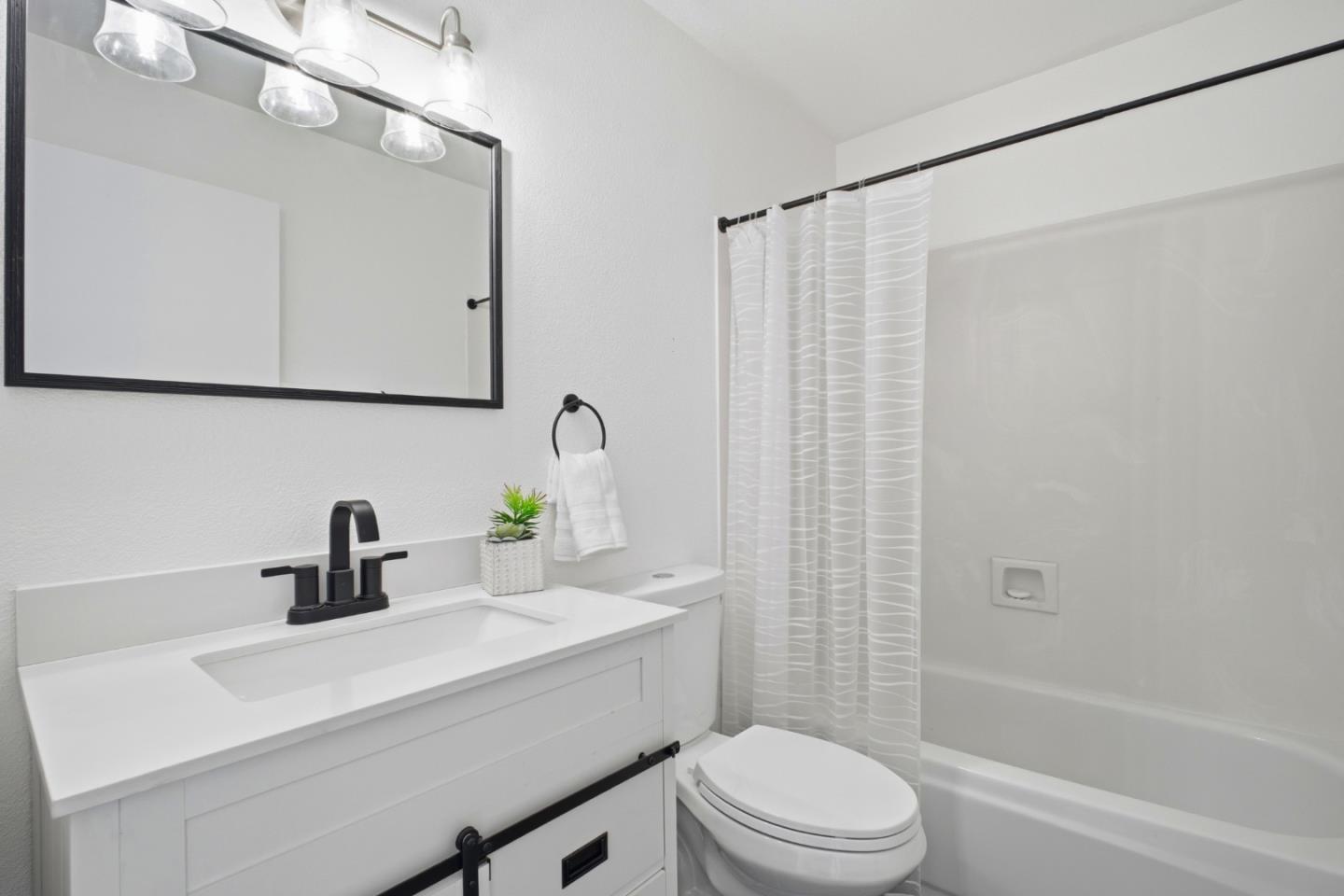 3950 Paul Terrace Fremont, CA 94538 - Photo 20 of 28 a bathroom with a sink a toilet a mirror and shower