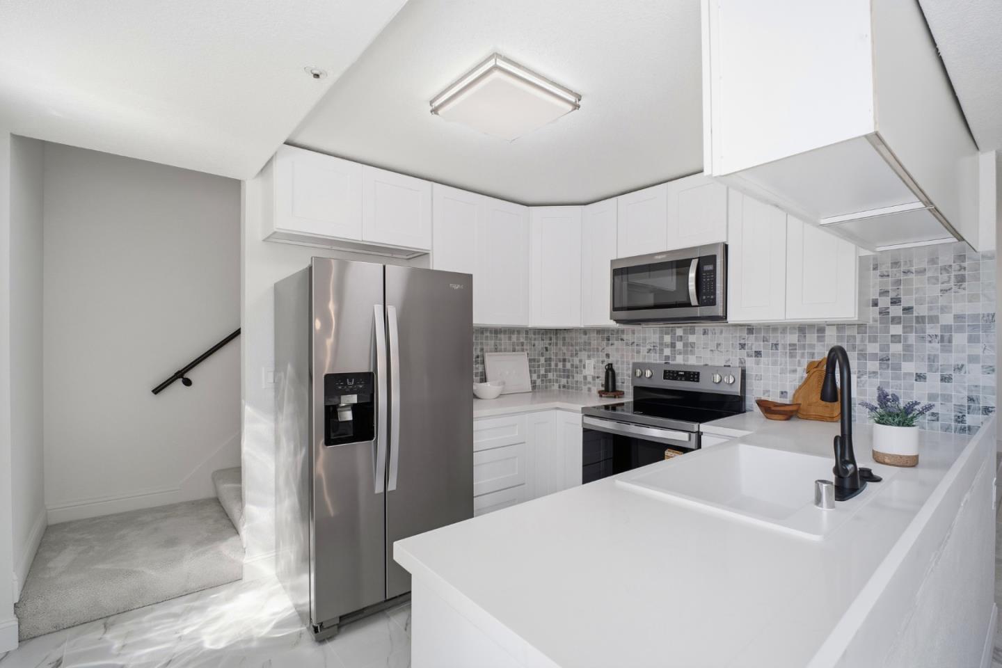 3950 Paul Terrace Fremont, CA 94538 - Photo 7 of 28 a kitchen with stainless steel appliances a refrigerator sink and microwave