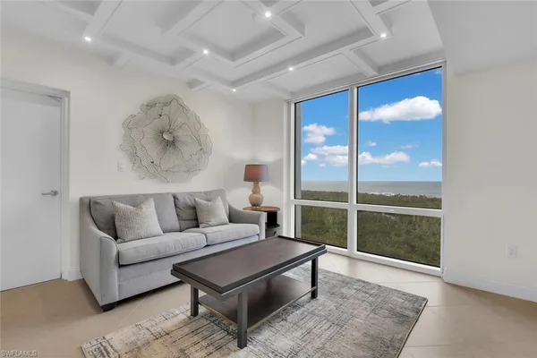 a living room with furniture a rug and a flat screen tv