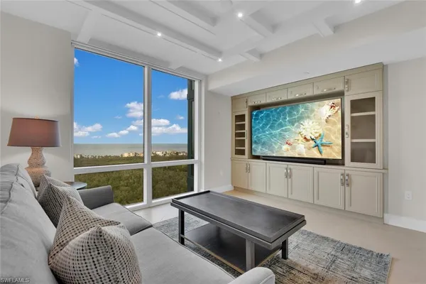 a living room with furniture a rug and white walls