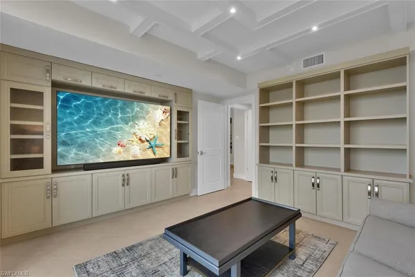 a living room with furniture floor to ceiling window and a table