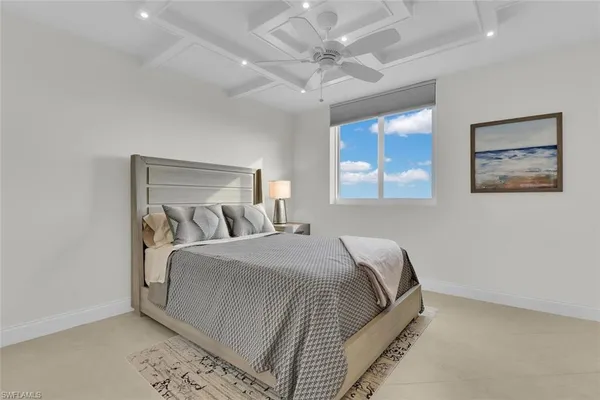 a bedroom with a bed and a painting on the wall