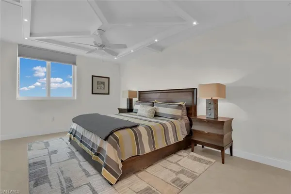 a bedroom with a bed and a painting on the wall