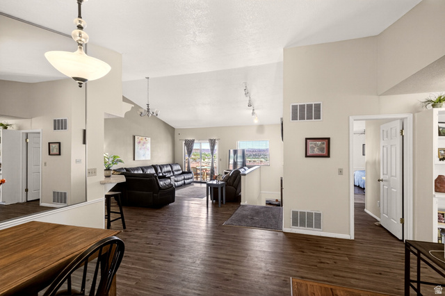 161 West 950 South, Unit Q1 St. George, UT 84770 - Photo 7 of 37 Living area with dark wood-type flooring, a high textured ceiling, and suspended lighting