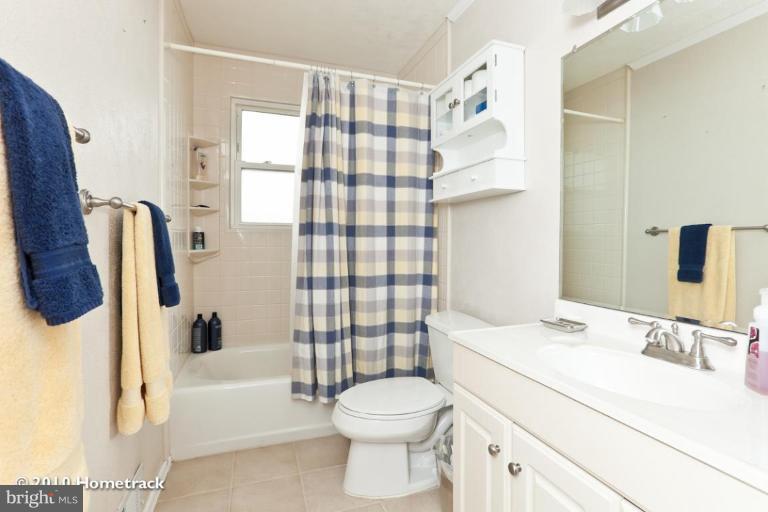8423 Kings Ridge Road Parkville, MD 21234 - Photo 13 of 21 a bathroom with a sink toilet and shower