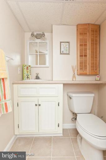 8423 Kings Ridge Road Parkville, MD 21234 - Photo 18 of 21 a bathroom with a sink a toilet and a window