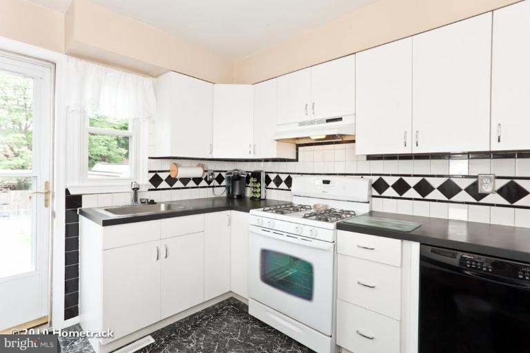8423 Kings Ridge Road Parkville, MD 21234 - Photo 8 of 21 a kitchen with a sink stove and cabinets