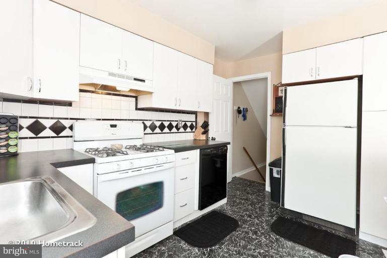 8423 Kings Ridge Road Parkville, MD 21234 - Photo 9 of 21 a kitchen with a stove a refrigerator and a sink