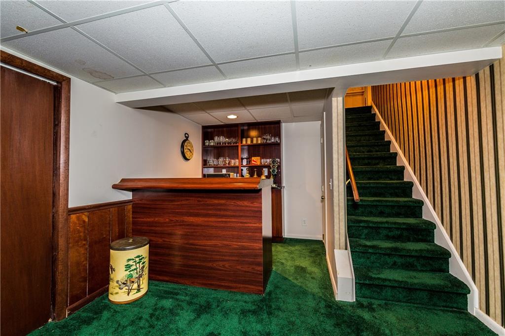 1624 Powers Run Road Pittsburgh, PA 15238 - Photo 12 of 25 GAME ROOM 24X21: Wet bar with built in shelves is a great place for your company to hang out. Wall of closet space is ideal for storage.